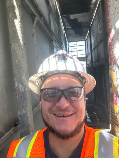 Shane Brooks on a jobsite, in hard hat and hi-vis